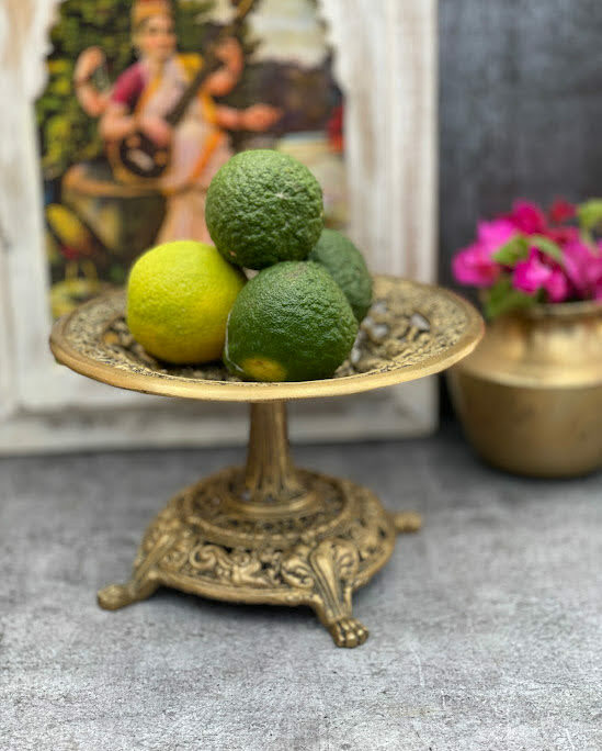 athepoo- A brass fruit stand with oranges