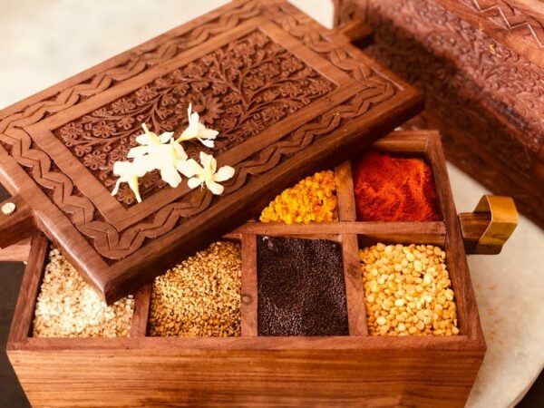 athepoo- A wooden spice box having some spices inside the box
